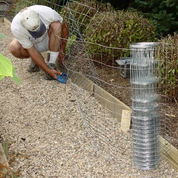 Secure fencing to buried boards to head off animal burrowing. © George Weigel